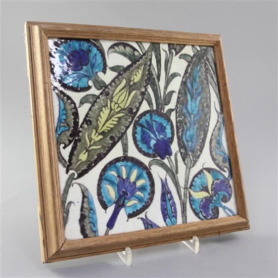 A large William de Morgan Iznik style pottery tile, 23cm, later oak frame